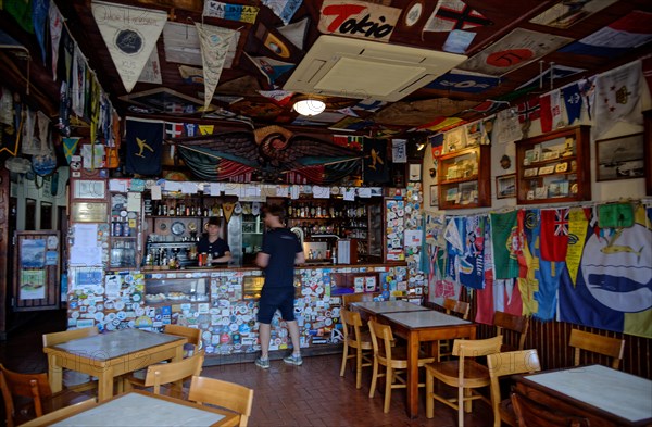 Interior view of the famous Cafe Sport with many flags and pennants from Atlantic crossings on the ceiling, Horta, Faial Island, Azores, Portugal, Europe