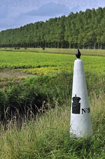 White boundary, border post between the Netherlands and Belgium in polder, Meetjesland