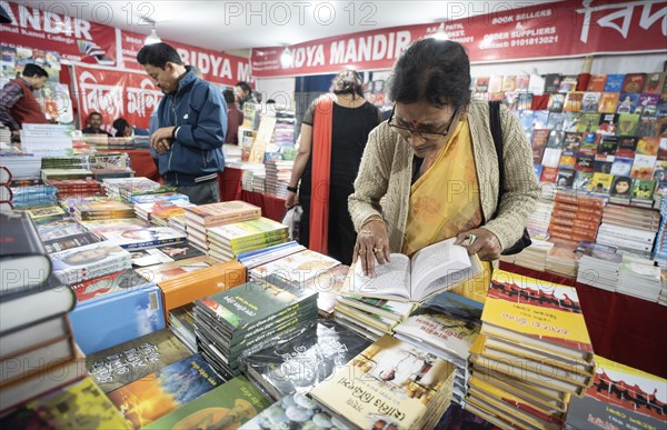 Book readers browsing books at a stall during Assam Book Fair, in Guwahati, Assam, India on 29 December 2023