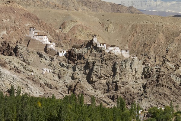 Basgo Gompa, the Buddhist monastery and fortress in Central Ladakh, with the village below it and rugged mountain landscape around. Leh District, Union Territory of Ladakh, India, Asia