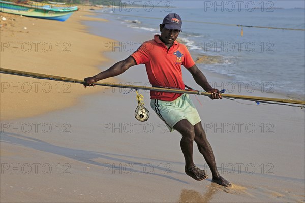 Traditional fishing hauling nets Nilavelli beach, near Trincomalee, Eastern province, Sri Lanka, Asia