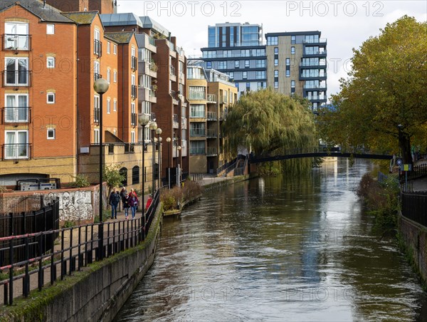 River Kennet flowing past apartment housing in town centre, view east from London Street Reading, Berkshire, England, UK