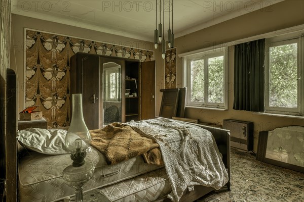 A chaotic, abandoned bedroom with an unmade bed and old furniture, Maison Limmi, Lost Place, Kalken, Laarne, Province of East Flanders, Belgium, Europe