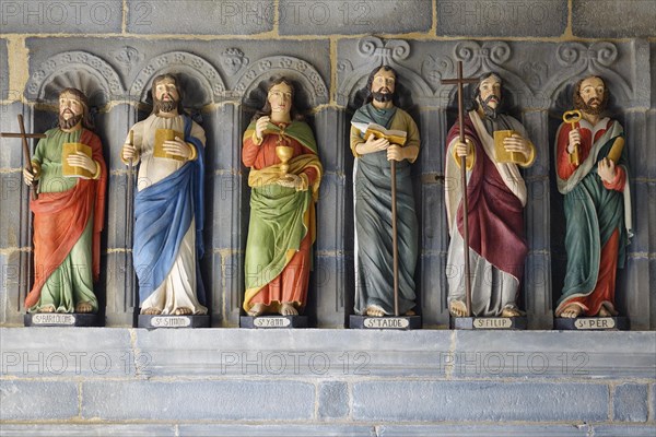 Six statues of saints in a restored version in front of the entrance to the Saint-Sauveur church on the Riviere du Faou on the Rade de Brest, Le Faou, Finistere department, Brittany region, France, Europe