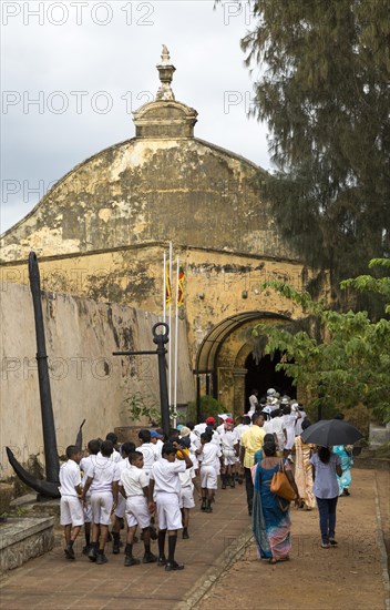 School children in uniform walking in a street in the historic town of Galle, Sri Lanka, Asia