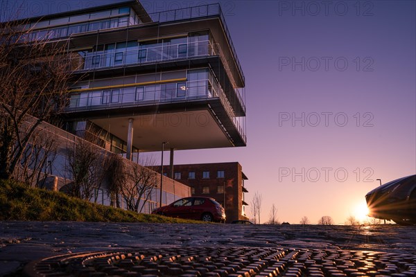 Modern residential building in the light of the sunset with parked cars, University, Pforzheim, Germany, Europe
