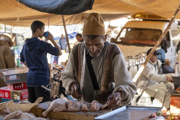 Man cutting up meat, weekly market market, Ourika, Morocco, Africa