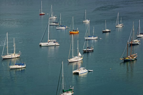 Several sailing boats on calm water with visible reflections, Monte da Guia, Horta, Faial Island, Azores, Portugal, Europe
