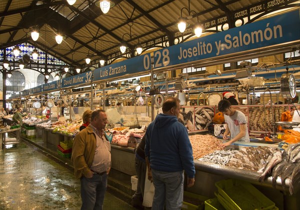 People shopping at fishmonger stalls inside historic covered market building, Jerez de la Frontera, Spain, Europe