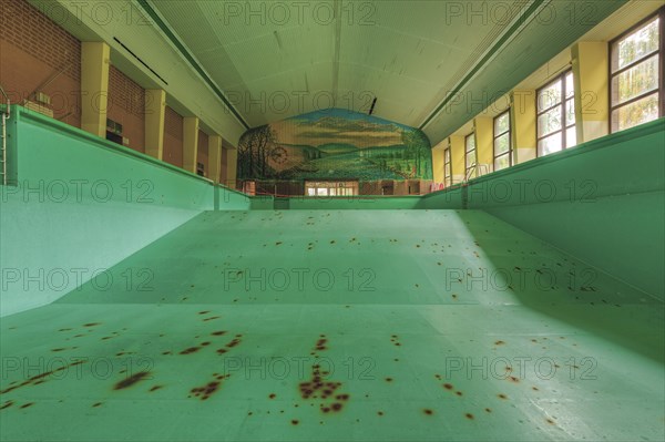 A dilapidated, empty swimming pool with rust stains on the floor, deserted atmosphere, Bad am Park, Lost Place, Essen, North Rhine-Westphalia, Germany, Europe