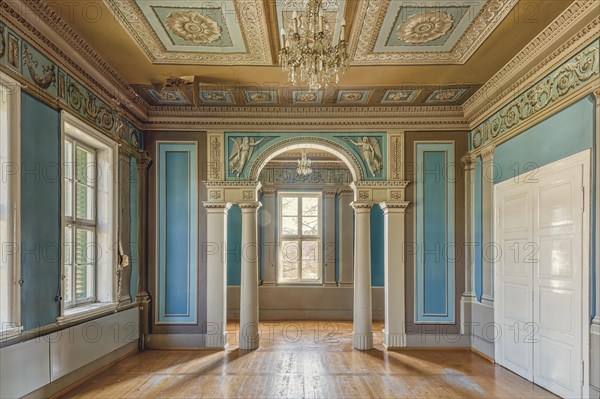 Sunlight floods a room with columns and an ornate ceiling with chandelier, Schachtrupp Villa, Lost Place, Osterode am Harz, Lower Saxony, Germany, Europe