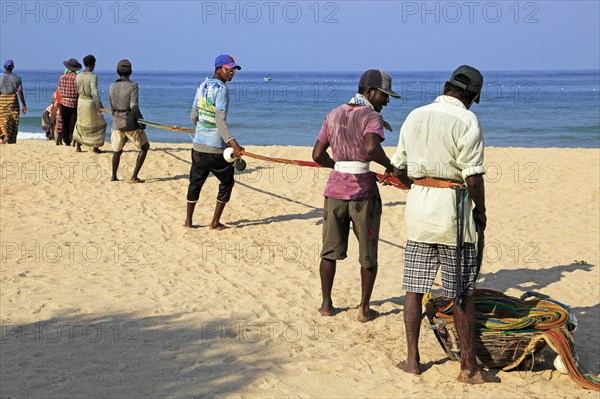 Traditional fishing hauling nets Nilavelli beach, near Trincomalee, Eastern province, Sri Lanka, Asia