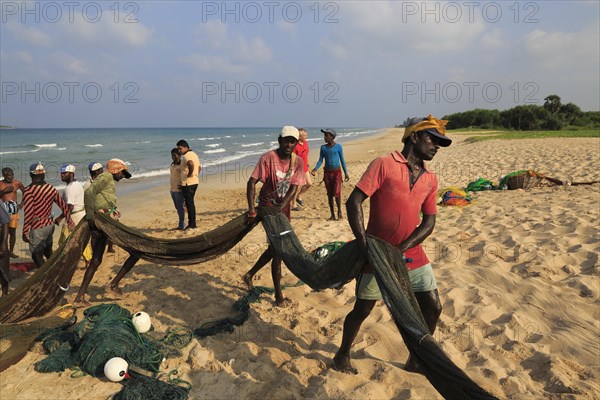 Traditional fishing hauling nets Nilavelli beach, near Trincomalee, Eastern province, Sri Lanka, Asia