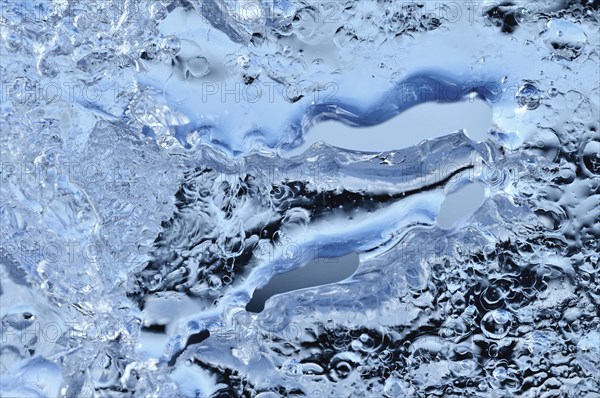Close-up of melting ice with air bubbles trapped inside