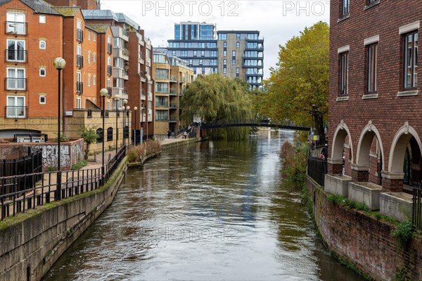 River Kennet flowing past apartment housing in town centre, view east from London Street Reading, Berkshire, England, UK