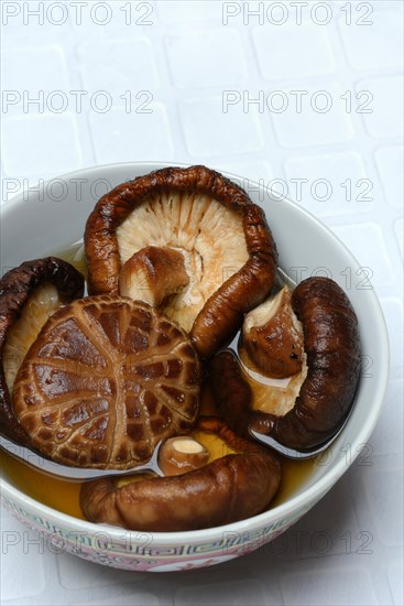 Dried shiitake mushrooms in a bowl, soaked in water