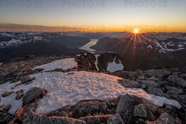 View of mountains and fjord Faleidfjorden, sun star at sunset, summit of Skala, Loen, Norway, Europe