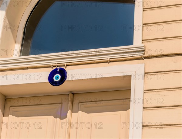Turkish evil eye protection nazar medallion on the top of doorway in Istanbul, Tuerkiye