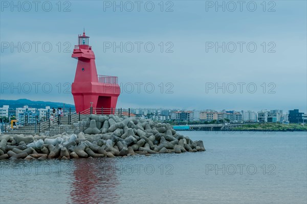 Red lighthouse built to look like horse on concrete prier in Jeju, South Korea, Asia