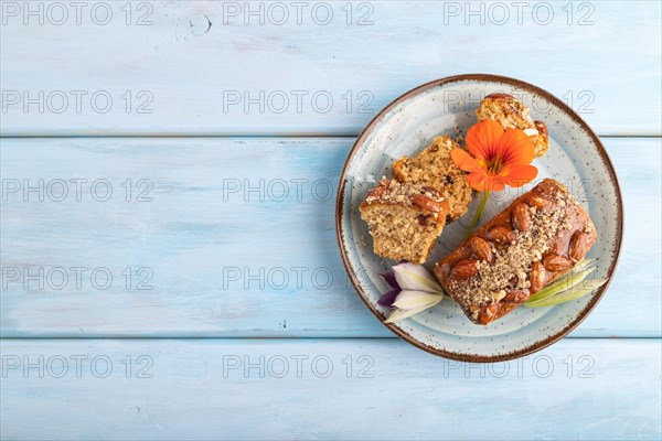Caramel and almond cake on blue wooden background. top view, flat lay, copy space