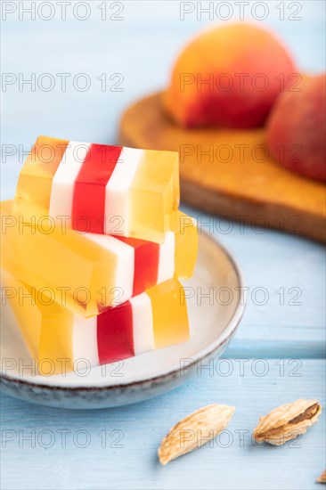 Almond milk and peach jelly on blue wooden background. side view, close up, selective focus