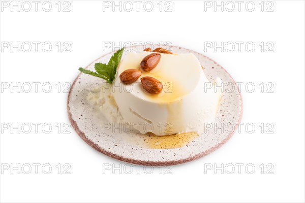 Ricotta cheese with honey and almonds isolated on white background. side view, close up