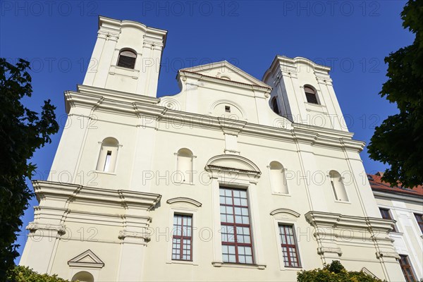 Baroque church facade with dominant towers under an intensely blue sky, Roman Catholic Church of St Francis Xavier, Skalica, Skalica, Trnavsky kraj, Slovakia, Europe