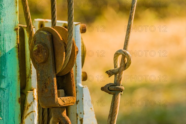 Closeup of a rusty pulley assembly with a blurred background in South Korea