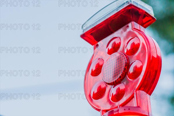 Closeup of red warning reflector against blurred background