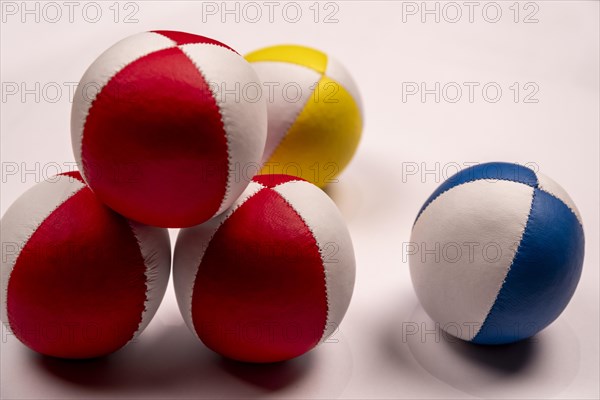 Several juggling balls in front of a white background, partially stacked, studio shot, Germany, Europe