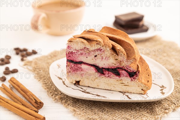 Zephyr or marshmallow cake with cup of coffee on white wooden background and linen textile. side view, close up, selective focus