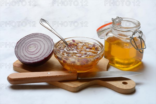 Honey in a jar and chopped onion as ingredients for cough syrup