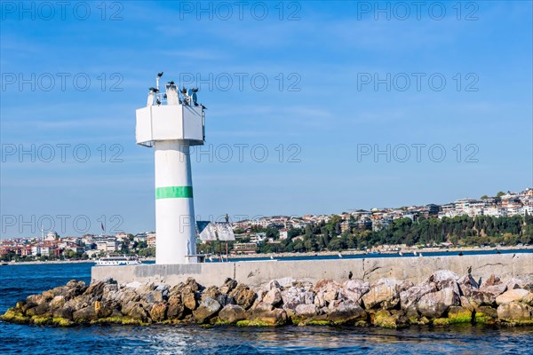 White lighthouse on concrete pier in Bosporus Strait in Istanbul Turkey