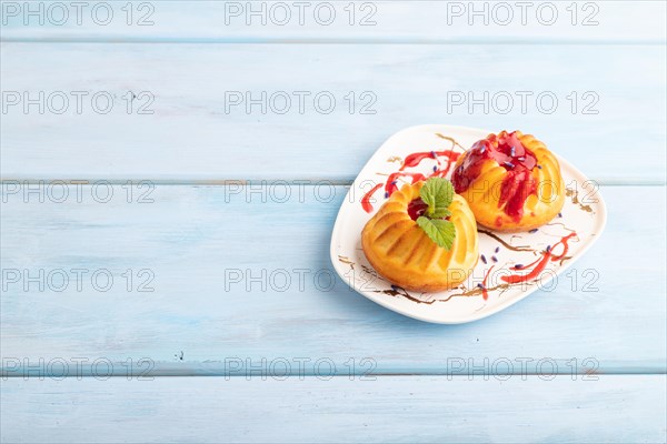 Semolina cheesecake with strawberry jam, lavender, on blue wooden background. side view, copy space