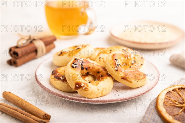 Homemade asian salted cookies, cup of green tea on gray concrete background and linen textile. side view, selective focus