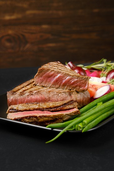 Grilled coulotte roast beef steak on dark background