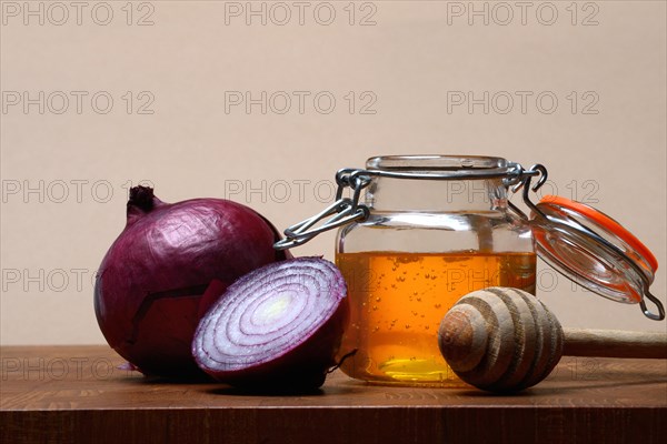 Honey in a jar and red onion, ingredients for cough syrup