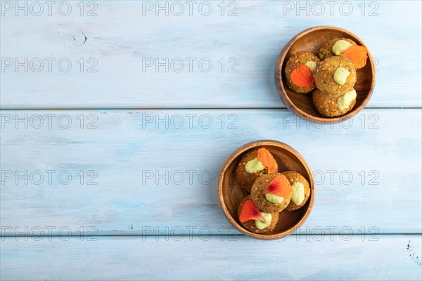 Falafel with guacamole on blue wooden background. Top view, flat lay, copy space