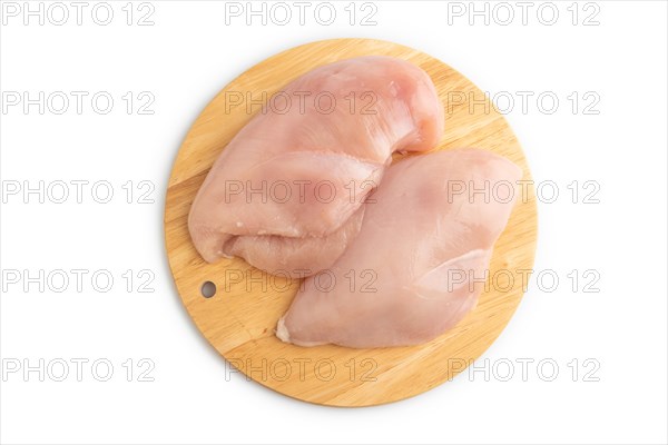 Raw chicken breast on a wooden cutting board isolated on white background. Top view, flat lay, close up