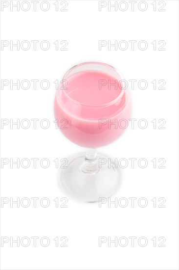 Sweet strawberry liqueur in glass isolated on white background. side view, close up