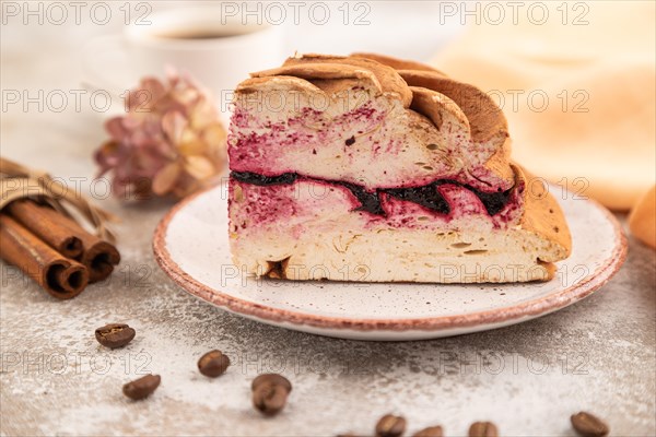 Zephyr or marshmallow cake with cup of coffee on brown concrete background and orange textile. side view, close up, selective focus