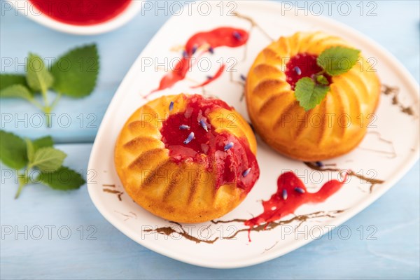 Semolina cheesecake with strawberry jam, lavender, cup of coffee on blue wooden background. side view, close up, selective focus