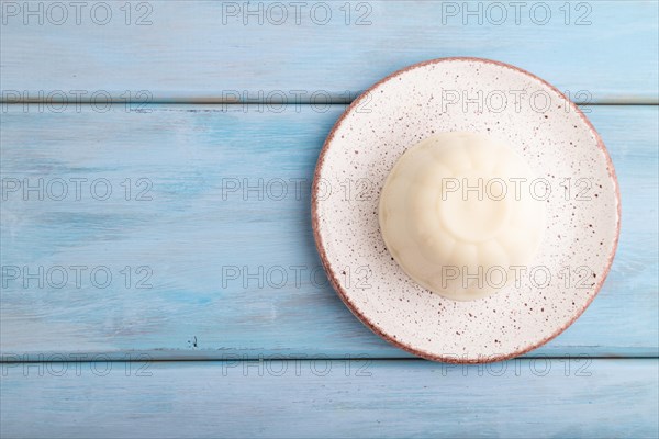 White milk jelly on blue wooden background. top view, flat lay, copy space