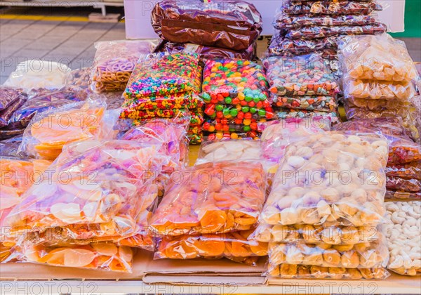 Clear bags of candy and dried fruit on display for sale at flea market in Sintanjin, South Korea, Asia