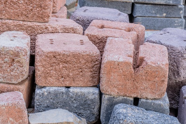 Closeup of used bricks stacked neatly in woodland construction site