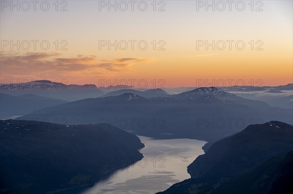 View of Faleidfjorden fjord, mountain peaks in soft light at sunset, view from the top of Skala, Loen, Norway, Europe