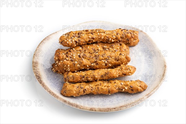 Crumble cookies with seasme and almonds on ceramic plate isolated on white background. side view, flat lay, close up