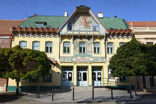 Colourful Art Nouveau cultural centre under a clear blue sky, flanked by trees, House of Culture, House of Culture, Skalica, Skalica, Trnavsky kraj, Slovakia, Europe