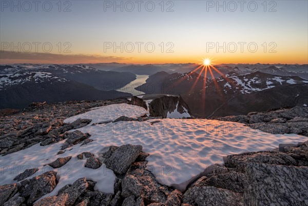 View of mountains and fjord Faleidfjorden, sun star at sunset, summit of Skala, Loen, Norway, Europe