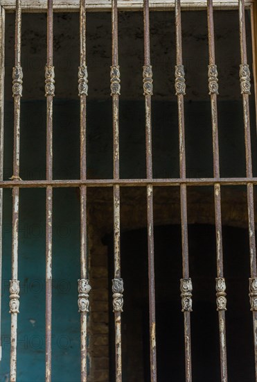 Bars over outside of glassless window in abandoned house in Istanbul, Tuerkiye